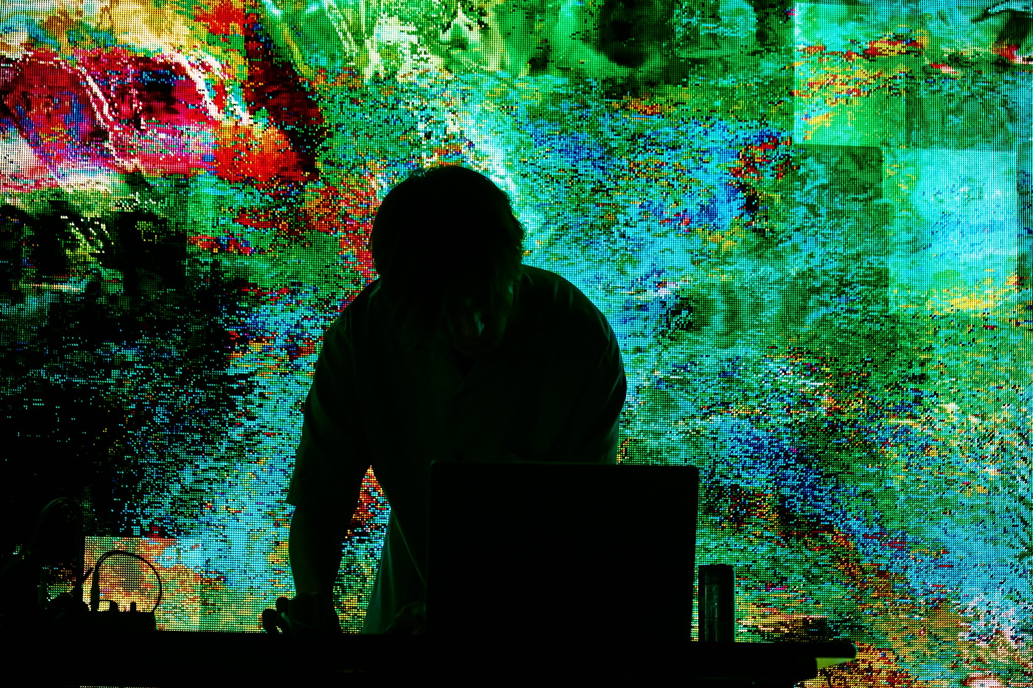 VJ performance in front of colorful visuals